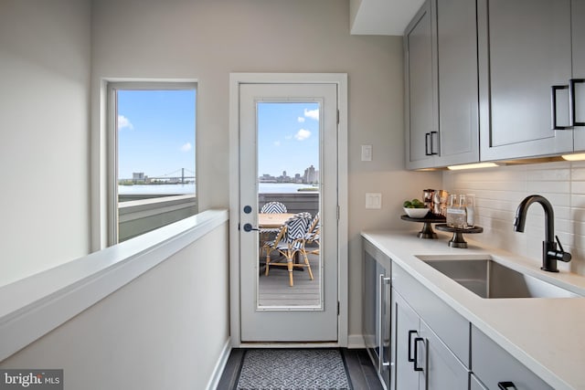 2001 Richmond St Unit 23B, Philadelphia, PA 19125 - bar featuring a sink, baseboards, and decorative backsplash