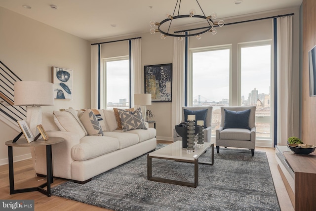 2001 Richmond St Unit 23B, Philadelphia, PA 19125 - living room featuring an inviting chandelier, stairs, baseboards, and wood finished floors