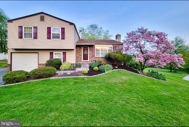 602 Oriole Ct, Harrisburg, PA 17111 - tri-level home with a garage, a chimney, a front lawn, and brick siding