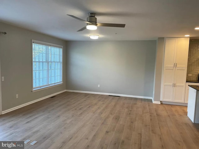 spare room featuring baseboards, recessed lighting, ceiling fan, and wood finished floors