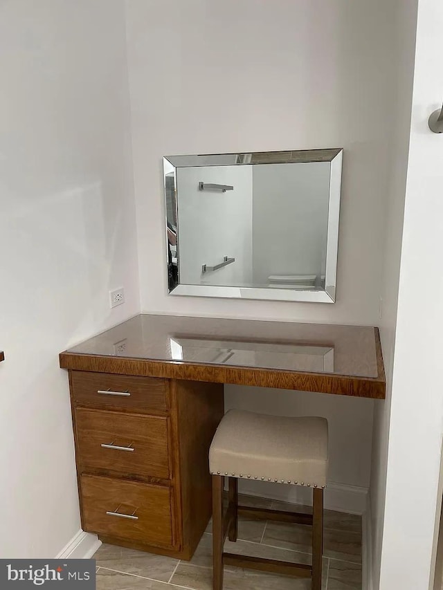 bathroom with vanity and baseboards
