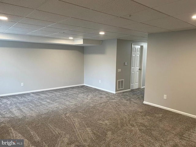 finished basement with visible vents, baseboards, dark carpet, a drop ceiling, and recessed lighting
