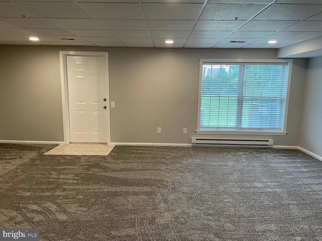 carpeted spare room featuring baseboards, baseboard heating, and a paneled ceiling