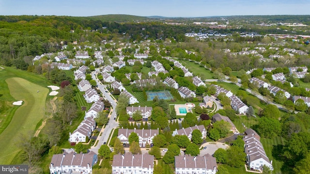 birds eye view of property with golf course view and a residential view