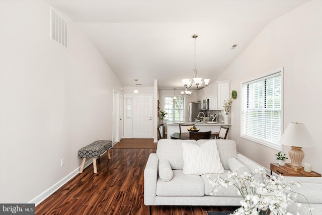 9 Fernwood Ct, Columbus, NJ 08022 - living room featuring a chandelier, dark wood finished floors, vaulted ceiling, and baseboards