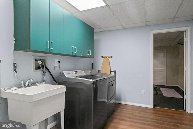 202 Trail Ct, Sterling, VA 20164 - laundry area featuring cabinet space, washing machine and dryer, dark wood-style floors, and baseboards