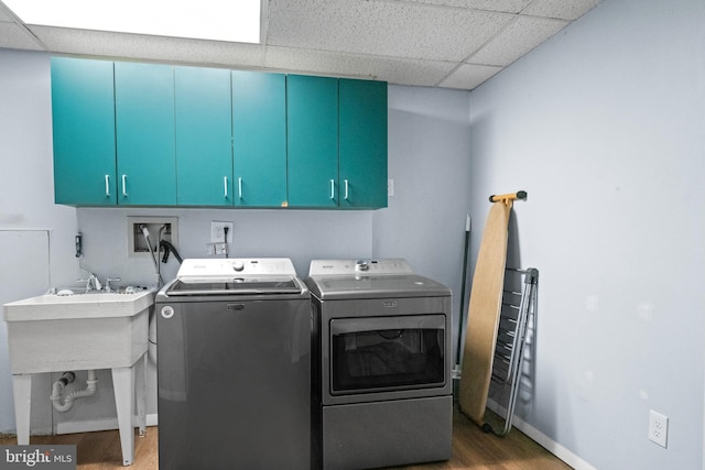 202 Trail Ct, Sterling, VA 20164 - laundry room featuring washing machine and clothes dryer, cabinet space, light wood finished floors, and baseboards