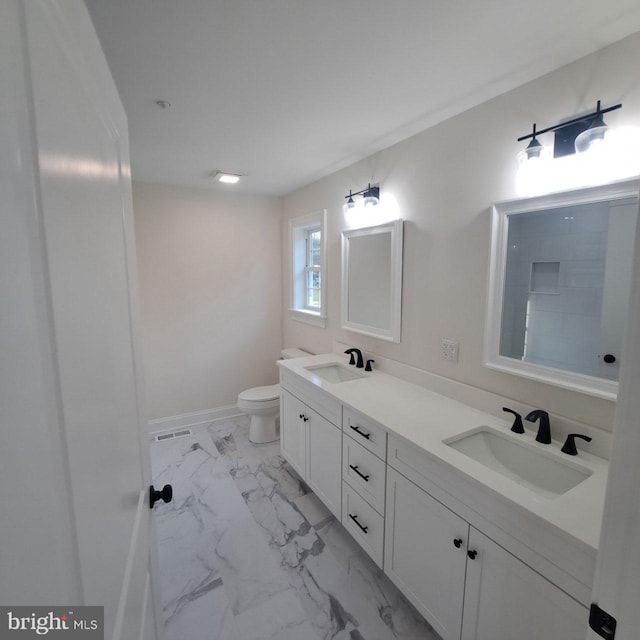 101 Thompson St, Hurlock, MD 21643 - full bathroom featuring double vanity, toilet, a sink, and marble finish floor