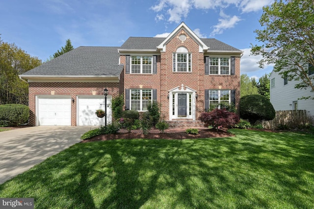 colonial house featuring brick siding, an attached garage, concrete driveway, and roof with shingles