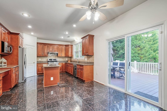 kitchen with appliances with stainless steel finishes, granite floors, recessed lighting, under cabinet range hood, and ceiling fan