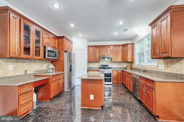 kitchen with stainless steel appliances, a sink, granite tiled floors, recessed lighting, and light stone countertops
