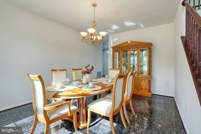 dining room with a chandelier and baseboards