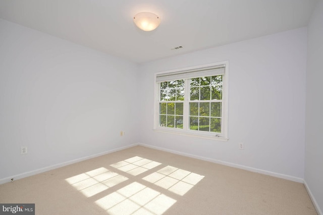 empty room featuring carpet floors and baseboards