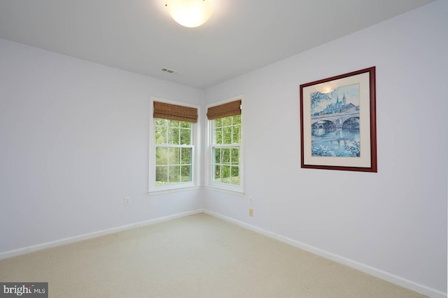 unfurnished room with carpet floors and baseboards