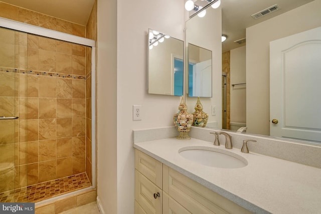 bathroom with a stall shower, toilet, and vanity