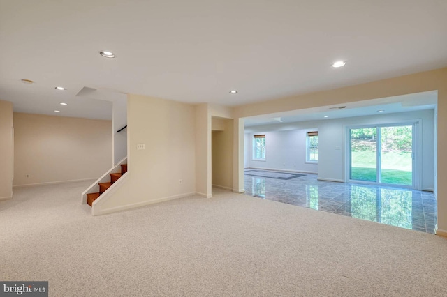 unfurnished room with recessed lighting, stairs, baseboards, and carpet