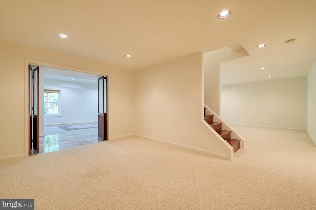 spare room featuring carpet floors, recessed lighting, stairs, and baseboards