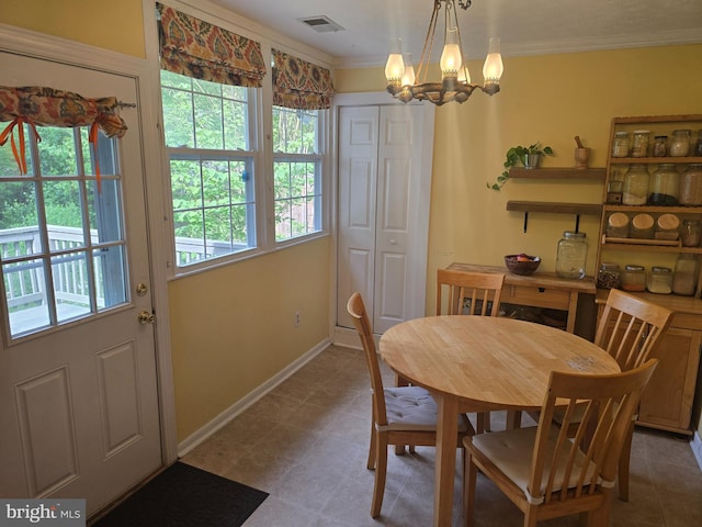 dining area featuring plenty of natural light, a chandelier, crown molding, and baseboards