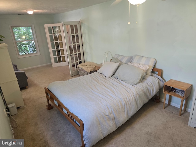 bedroom featuring carpet flooring, french doors, and baseboards
