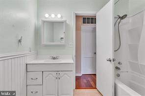 bathroom featuring vanity and tub / shower combination