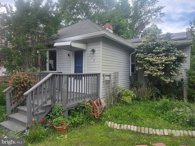 view of front of home featuring a chimney