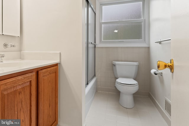 100 Furnlea Dr, Glen Burnie, MD 21060 - bathroom with toilet, tile patterned floors, vanity, tile walls, and combined bath / shower with glass door