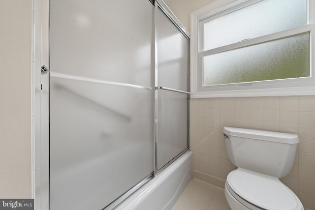 100 Furnlea Dr, Glen Burnie, MD 21060 - bathroom with toilet, shower / bath combination with glass door, tile patterned flooring, and tile walls