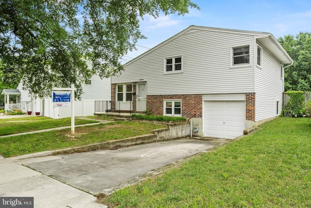100 Furnlea Dr, Glen Burnie, MD 21060 - tri-level home featuring brick siding, concrete driveway, a front yard, and a garage