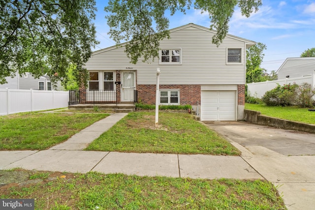 100 Furnlea Dr, Glen Burnie, MD 21060 - tri-level home featuring brick siding, a garage, and driveway