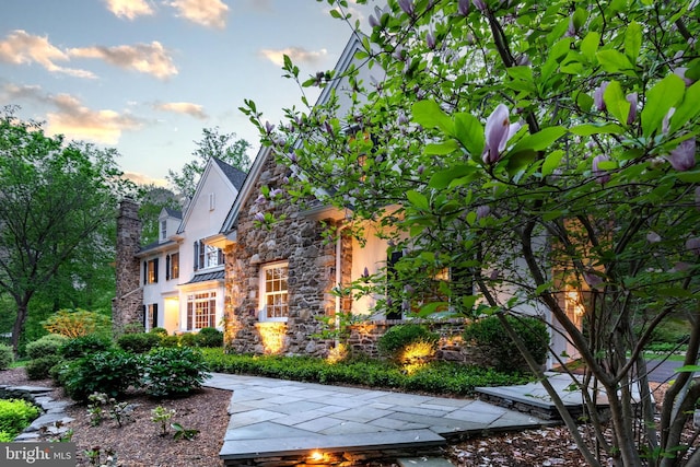 view of home's exterior featuring stone siding and stucco siding