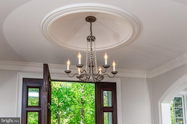 room details with arched walkways, a chandelier, and crown molding