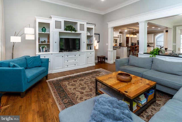 living area with ornamental molding, dark wood finished floors, recessed lighting, and decorative columns