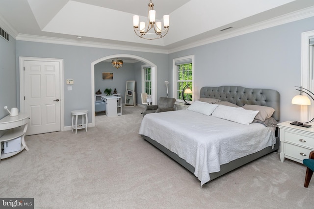bedroom with arched walkways, a notable chandelier, a tray ceiling, and carpet floors