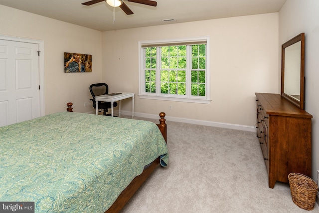 bedroom with light colored carpet, visible vents, baseboards, and ceiling fan