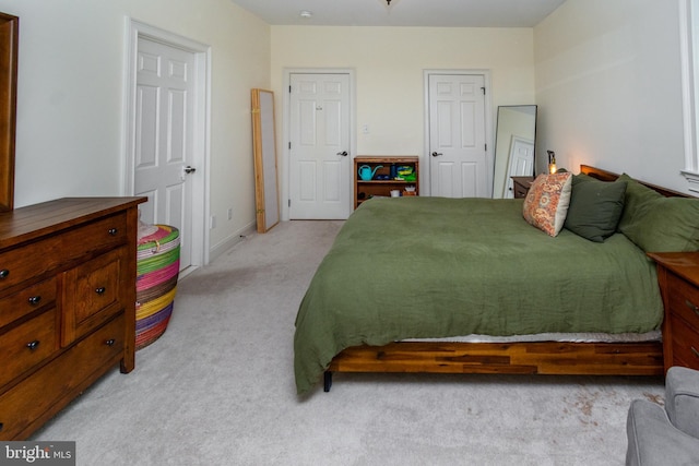 bedroom featuring light carpet
