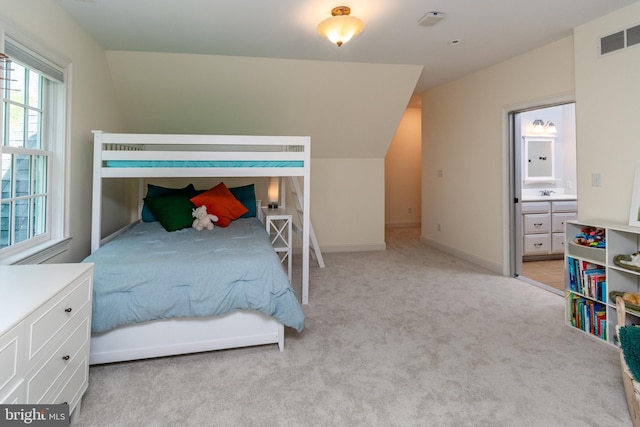 bedroom with multiple windows, visible vents, lofted ceiling, and light carpet