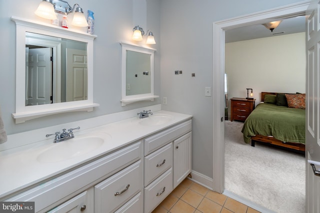 ensuite bathroom featuring a sink, double vanity, ensuite bathroom, and tile patterned flooring