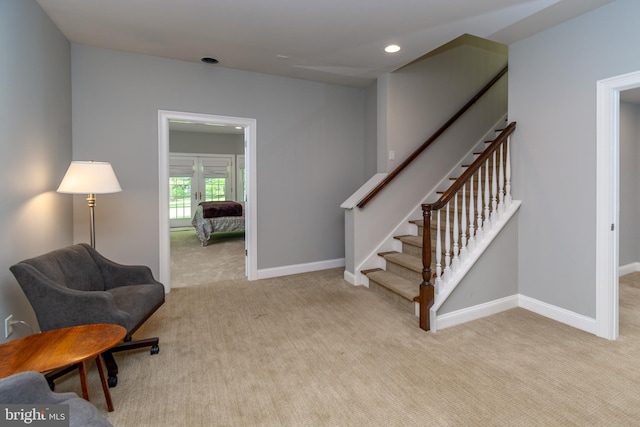 living area featuring carpet flooring, stairway, recessed lighting, and baseboards