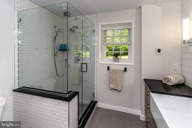 full bathroom with a stall shower, baseboards, toilet, tile patterned floors, and vanity