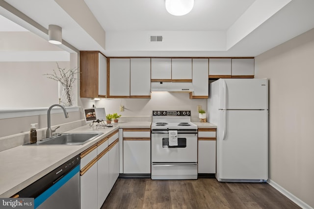 135 Woodlake Dr, Marlton, NJ 08053 - kitchen featuring white appliances, under cabinet range hood, a sink, light countertops, and dark wood-type flooring