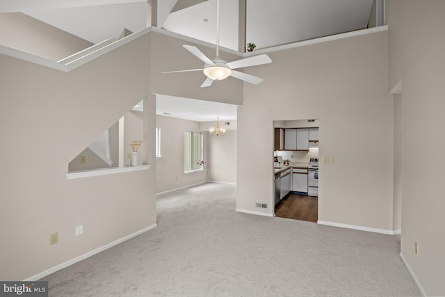 135 Woodlake Dr, Marlton, NJ 08053 - unfurnished living room with dark carpet, a chandelier, a ceiling fan, baseboards, and a towering ceiling