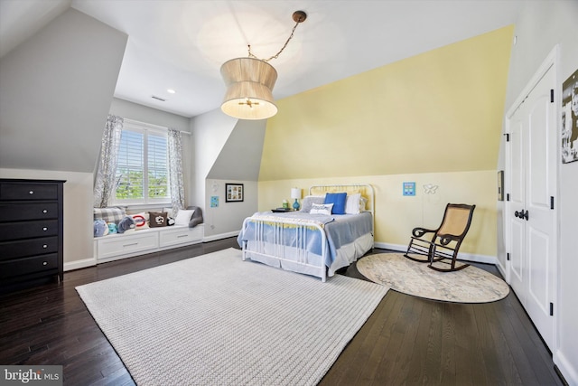 bedroom with baseboards, vaulted ceiling, and hardwood / wood-style floors