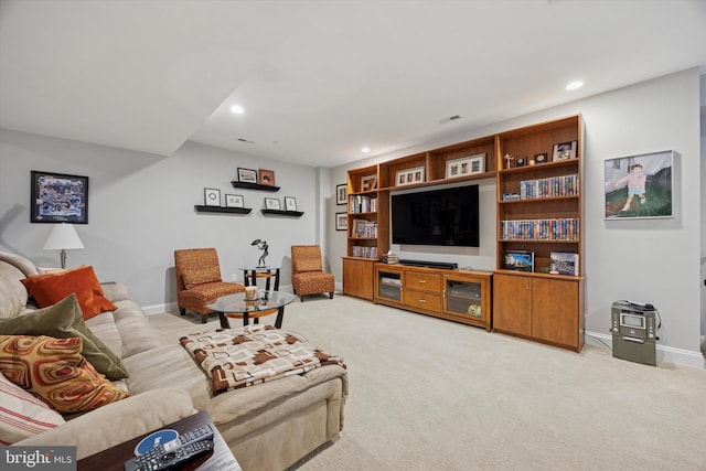 living room featuring baseboards, light carpet, and recessed lighting