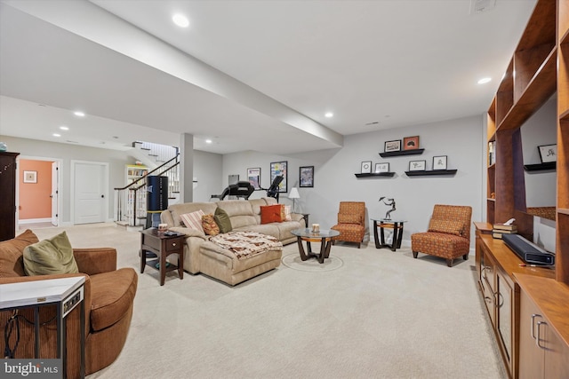living room featuring recessed lighting, light carpet, and stairway