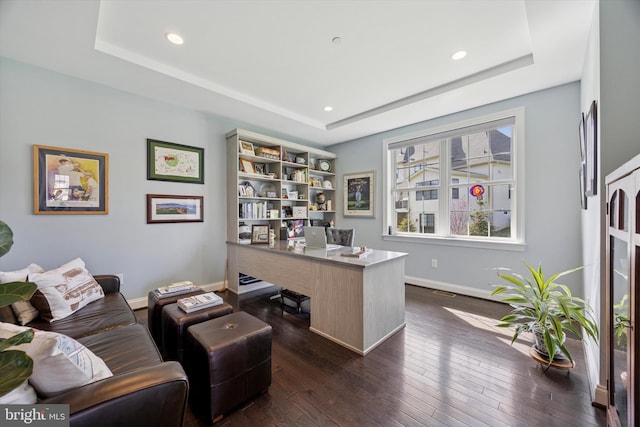 office area featuring baseboards, recessed lighting, a raised ceiling, and dark wood-style floors
