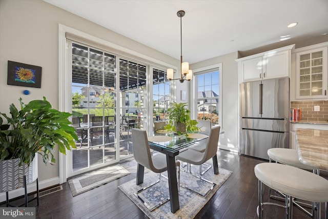 dining room featuring baseboards, recessed lighting, a chandelier, and dark wood-type flooring