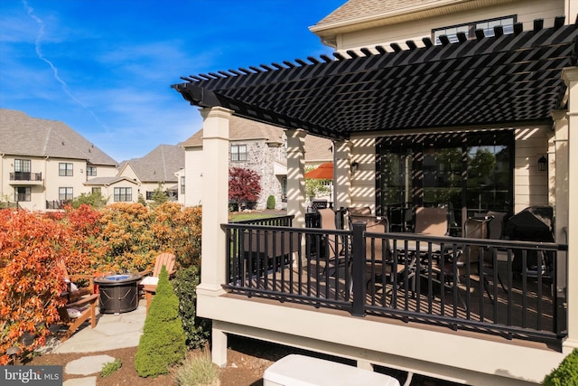wooden terrace with a residential view and a pergola