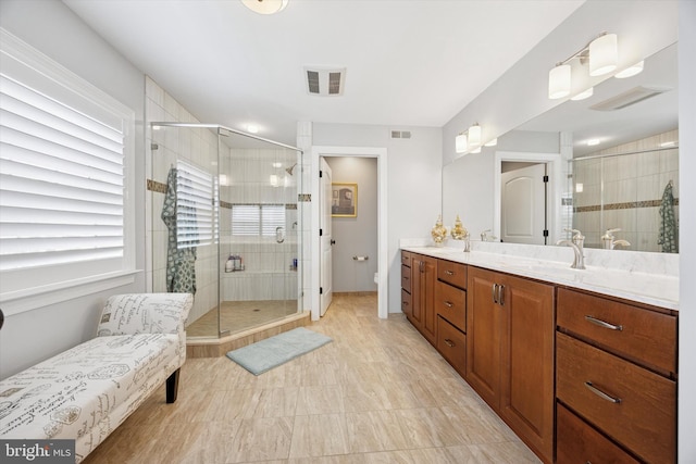 bathroom with toilet, visible vents, a shower stall, and vanity