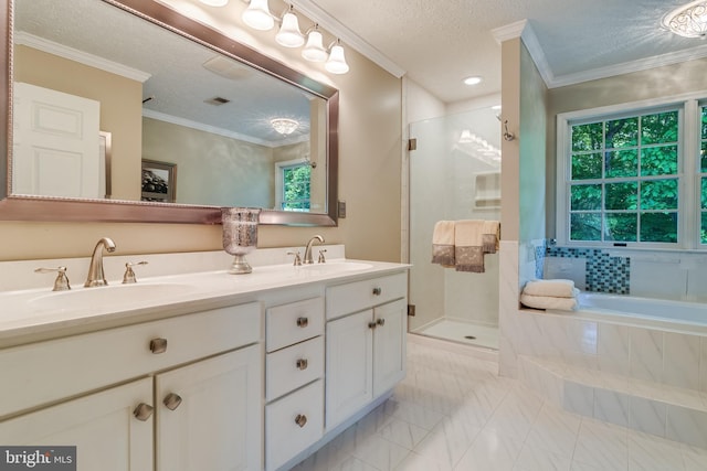 full bath with double vanity, a sink, a textured ceiling, and a stall shower