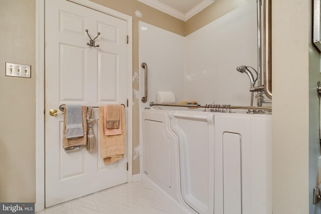 full bath with ornamental molding and marble finish floor